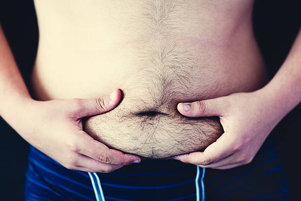 Fat hairy belly Fat hairy belly in hands. hairy fat man pictures stock pictures, royalty-free photos & images