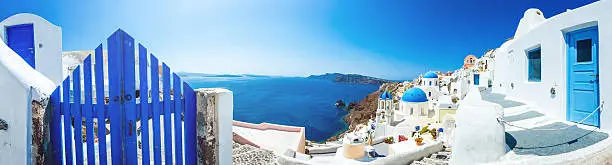 Panorama of Santorini caldera with famous Orthodox churches with blue domes in village Oia (Ia). Click for more images: http://santoriniphoto.com/Template-Greek.jpg