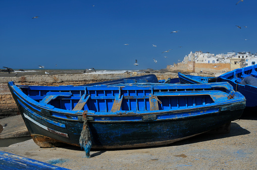 Blue fishing boats tied together in Essaouira, Morocco.