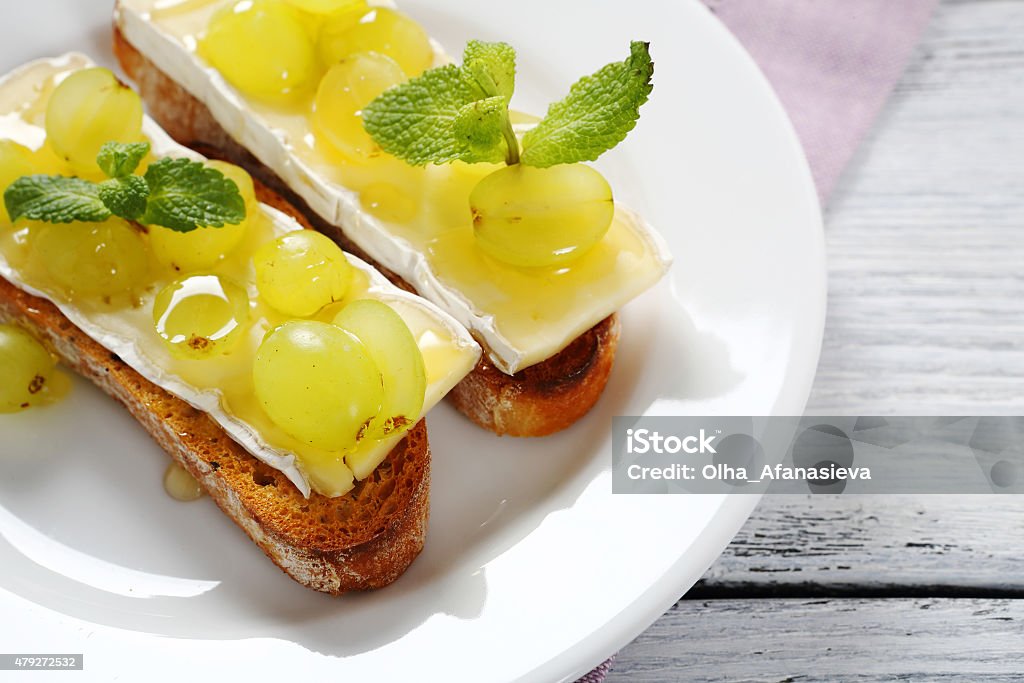 crostini with cheese and grapes crostini with cheese and grapes, italian food 2015 Stock Photo