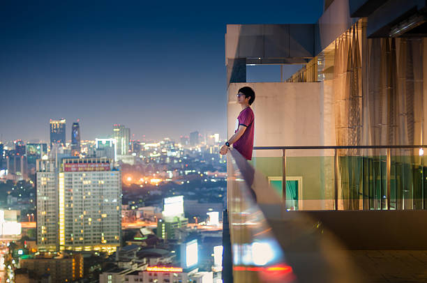 istock Men standing on the rooftop of a skyscraper over  cityscape 479272990