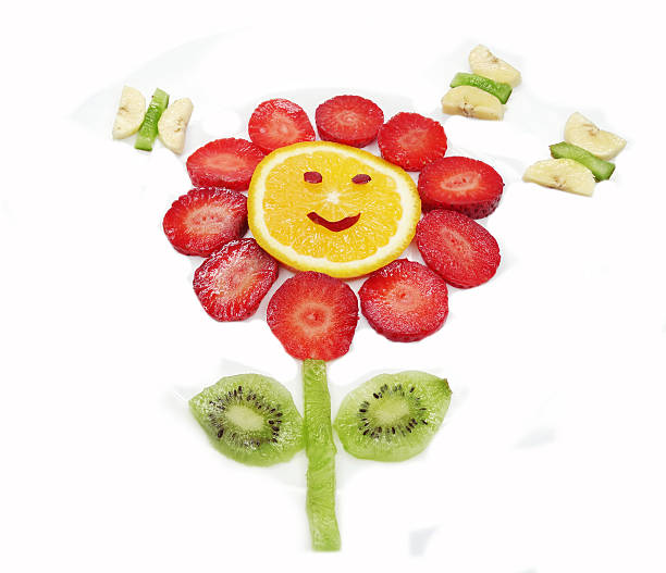 istock creative fruit child dessert red flower and butterflies form 479274416