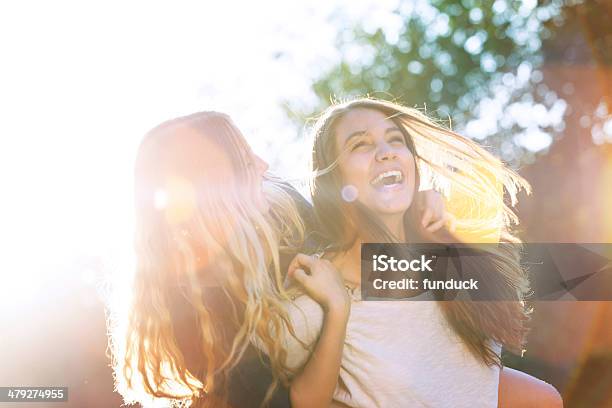 Two Teenagers Laughing At The Park Stock Photo - Download Image Now - Friendship, Teenage Girls, Teenager