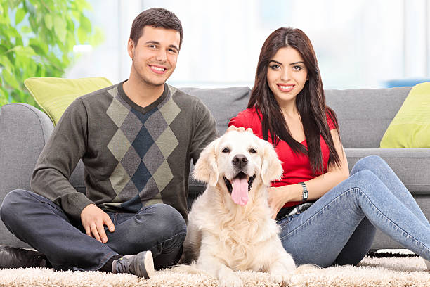 istock Young couple sitting on the floor with a dog 479281192