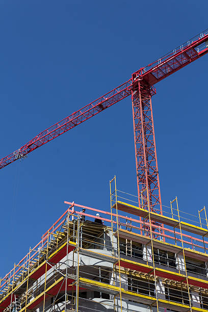 istock building facade with scaffolding and crane - construction site 479281340