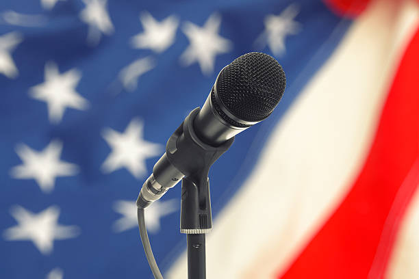 istock Microphone on stand with USA flag on background 479281496