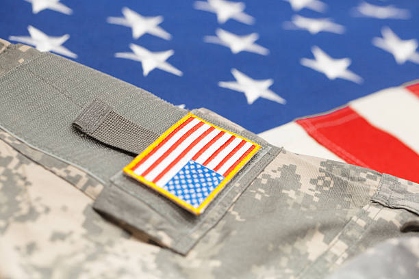 istock USA flag with army uniform - close up studio shot 479281500