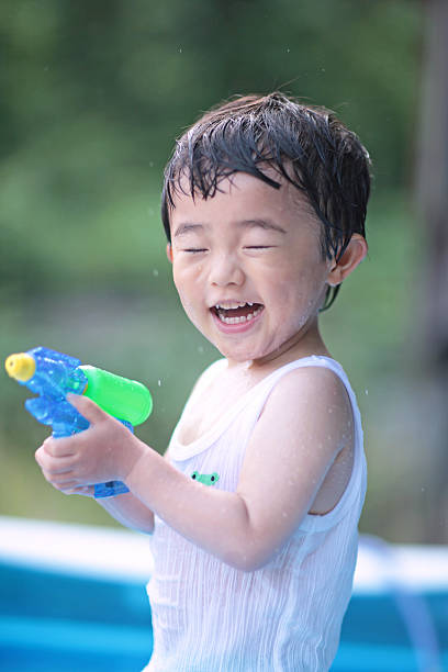 istock Boy playing in the water gun 479281571