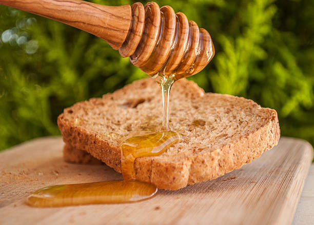 istock toasted bread with honey and honey dipper 479286370
