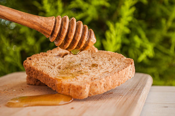 istock toasted bread with honey and honey dipper 479286392