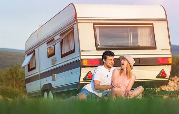 istock Young couple with a camper van 479286552