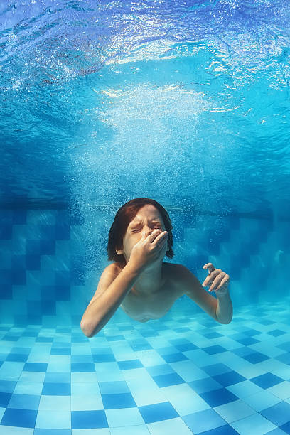 istock Little boy swimming underwater in the blue pool 479287100