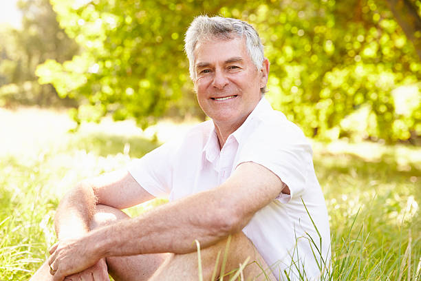 istock Senior man sitting on grass relaxing 479287876