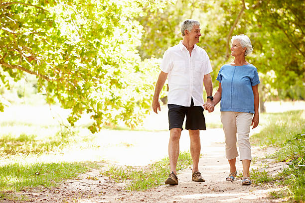 istock Senior couple walking on a path together in the countryside 479287894