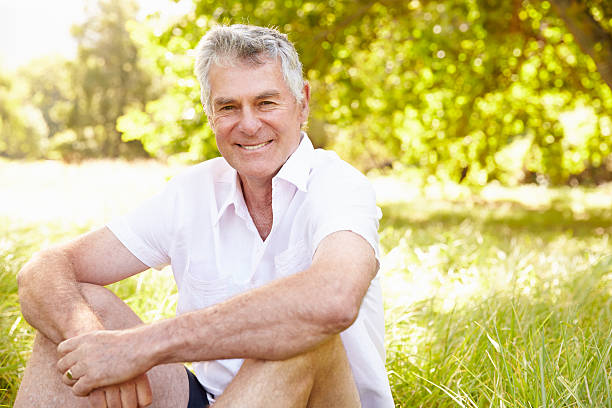 istock Senior man sitting on grass relaxing 479287910