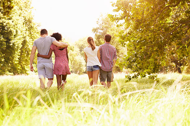 istock Two couples walking together in the countryside, back view 479287954