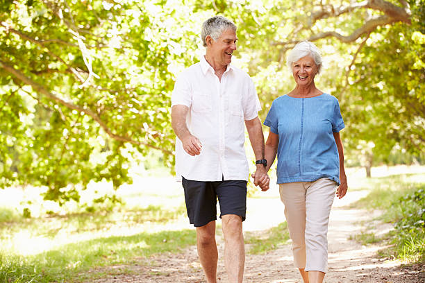 istock Senior couple walking on a path together in the countryside 479287956