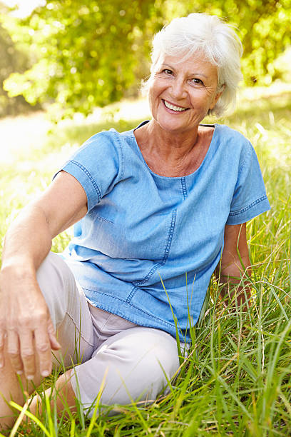 istock Senior woman sitting on grass relaxing 479287962