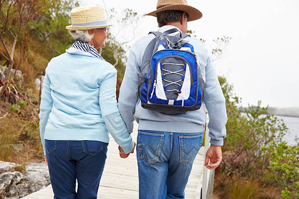 istock Senior couple walking together by a lake 479287964