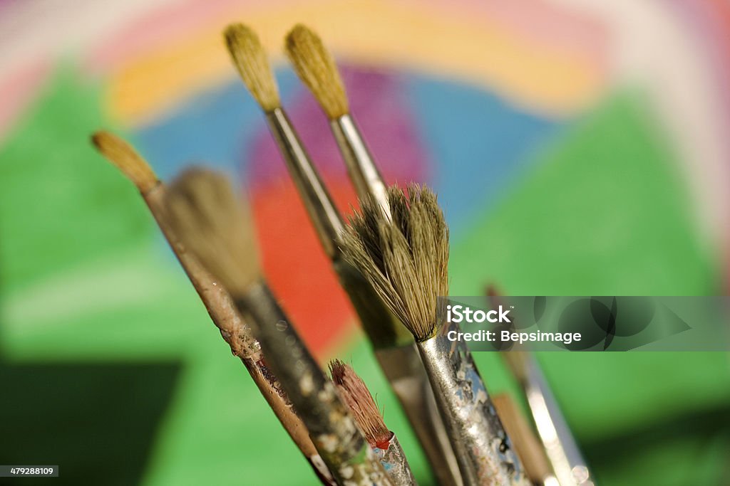 Paintbrushes Paintbrushes and painted canvas in the background Art Stock Photo