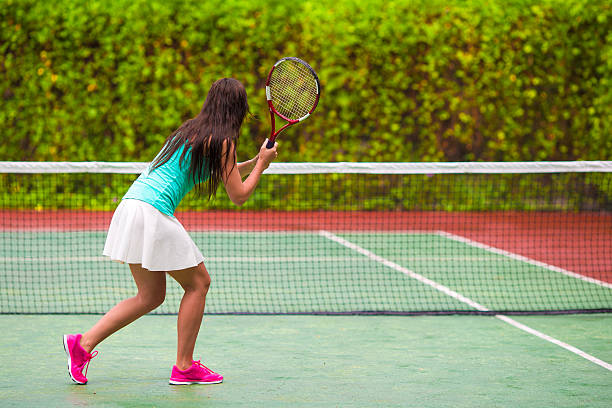 istock Young active woman playing tennis on tropical vacation 479289670