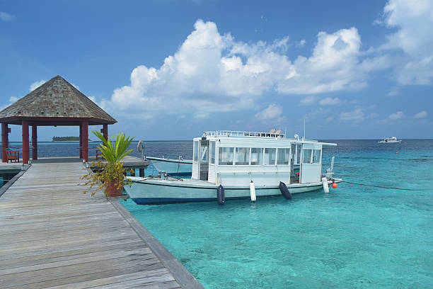 Pier leading to passenger boats at maldive stock photo