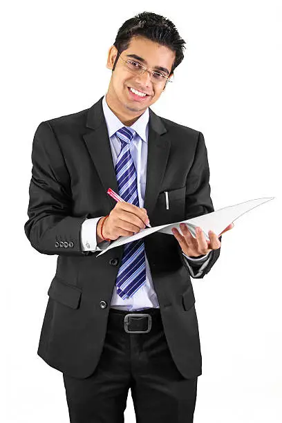 Photo of young business man writing on his notepad