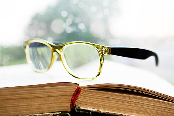 istock Reading glasses and book on rainy window 479291844