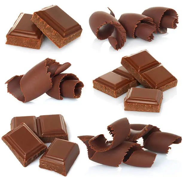 Chocolate shavings with blocks set on white background close-up