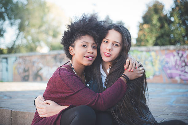 istock two multiethnic beautiful young woman black and white having fun 479293204