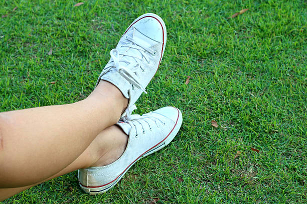 istock White shoes on a green grass background. 479293660