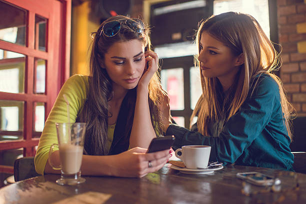 istock Sad woman reading text message to her friend in cafe. 479297434