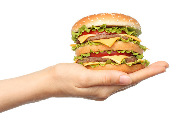 istock Hand holds big hamburger on white background 479298670