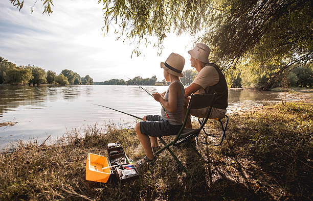 istock Father and son bonding during fishing day on the river. 479299618