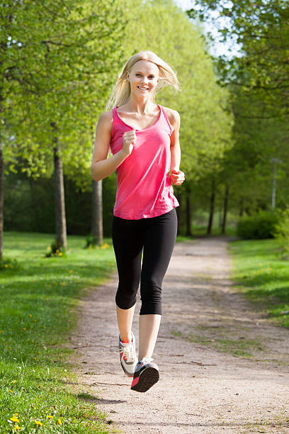 istock Happy Young Woman Jogging In Park 479300416
