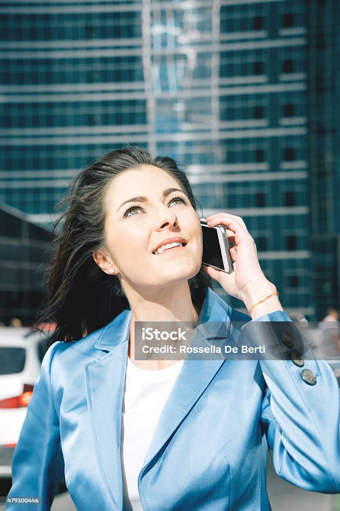 Successful Businesswoman On The Phone In Urban Landscape Successful businesswoman on the phone in urban landscape. 2015 Stock Photo