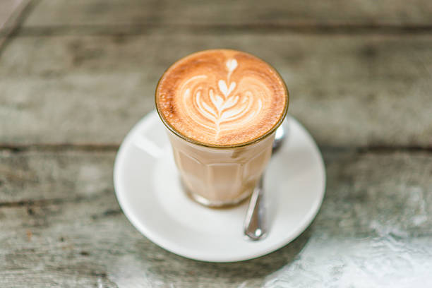 istock Art latte coffee with leaf pattern on wooden background 479303246