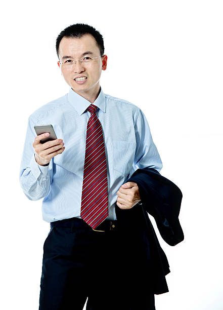 Young asian businessman holding a mobile phone isolated on white background.