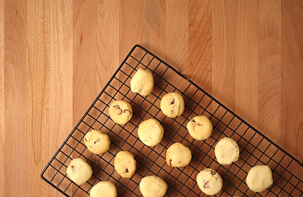 Freshly baked cookies on a tray served on kitchen table stock photo