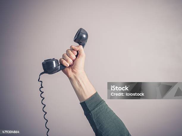 Hand Of Young Man Holding Vintage Phone Stock Photo - Download Image Now - Old, Men, Telephone