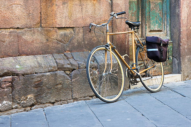 istock Yellow bicycle with bag against a stone wall 479305552