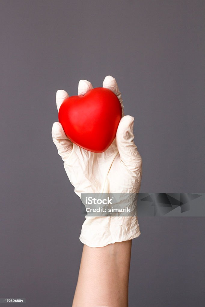 Doctor Holding Heart Doctor holding heart, vertical 2015 Stock Photo