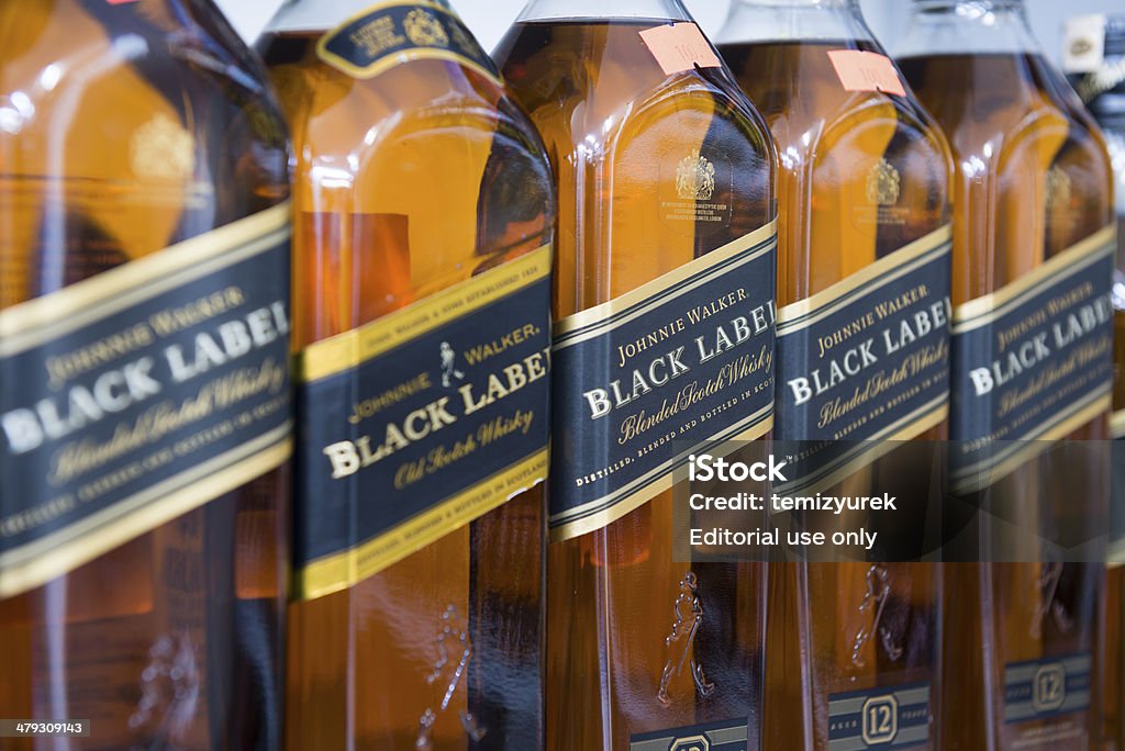 Johnnie Walker, Black Label Antalya, Turkey - February 12, 2014: Close-up shot bottles of Johnnie Walker, Black Label on the market shelf are waiting to be purchased by consumers.. Johnnie Walker is a brand of Scotch Whisky owned by Diageo and originated in Kilmarnock, Ayrshire, Scotland. Label Stock Photo