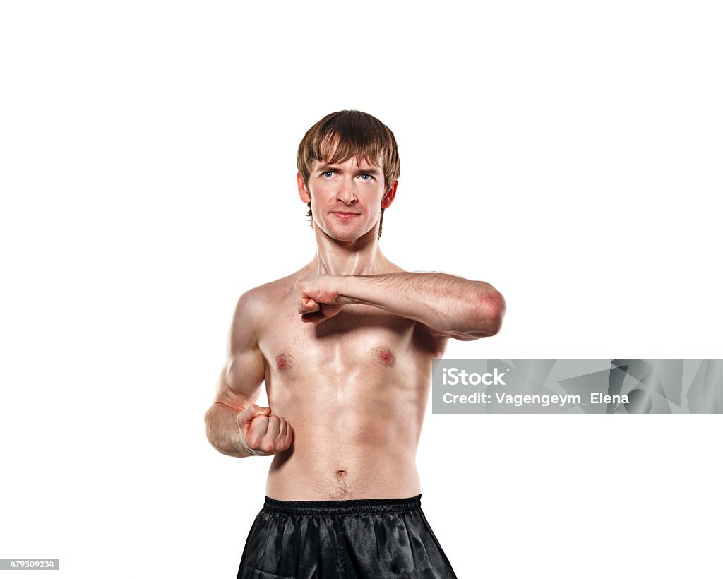 Fighter Kung Fu is preparing to kick The man trains kata kung fu training to strike. Isolated on white background. The concept of masculine strength and a healthy lifestyle. 2015 Stock Photo