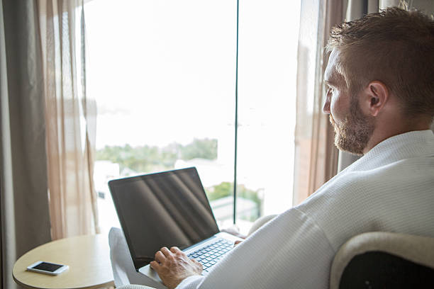 istock Businessman in hotel room using a laptop 479309292