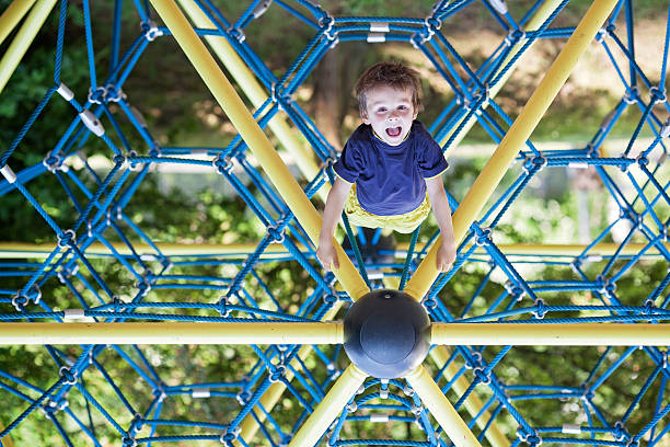 istock Sweet boy on the playground, hanging upside down 479309864