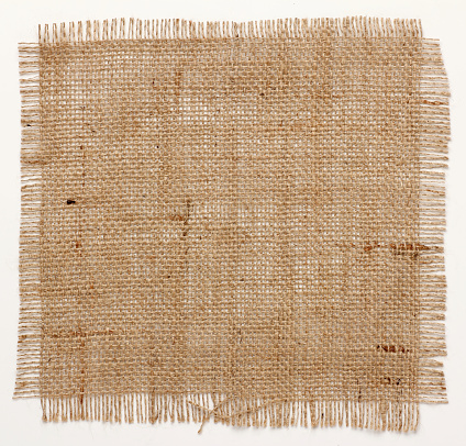 texture of Burlap hessian square with frayed edges on white background