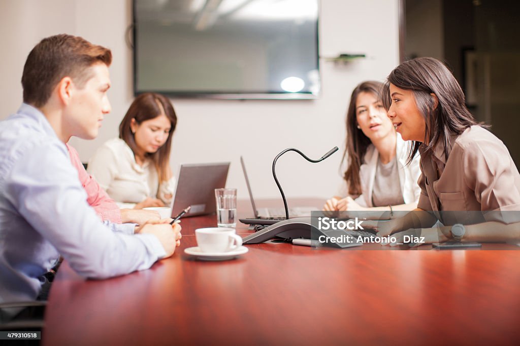 People on a conference call Group of people talking to a microphone over a conference call at work Conference Call Stock Photo