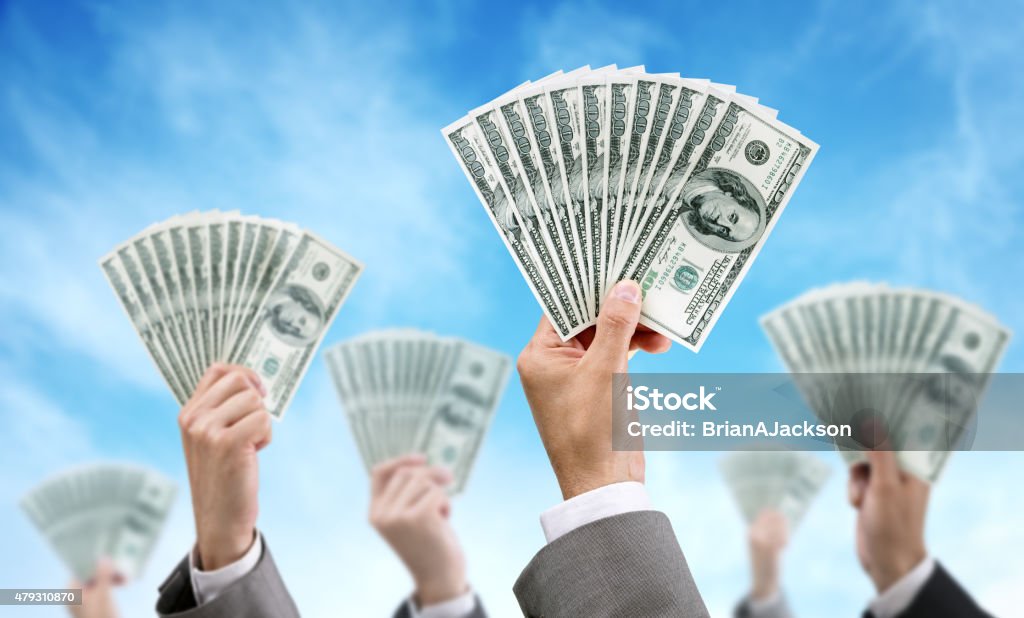 Crowd funding finance and investment Venture capital or crowd funding finance and investment concept businessmen holding up dollar currency aloft Venture Capital Stock Photo