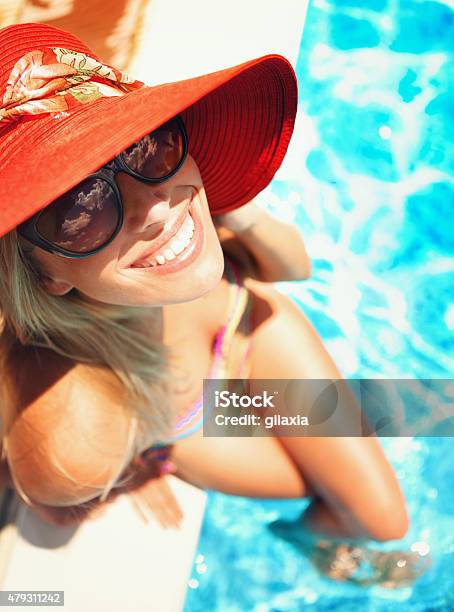 Woman Relaxing By Swimming Pool Stock Photo - Download Image Now - 20-29 Years, 2015, 30-39 Years